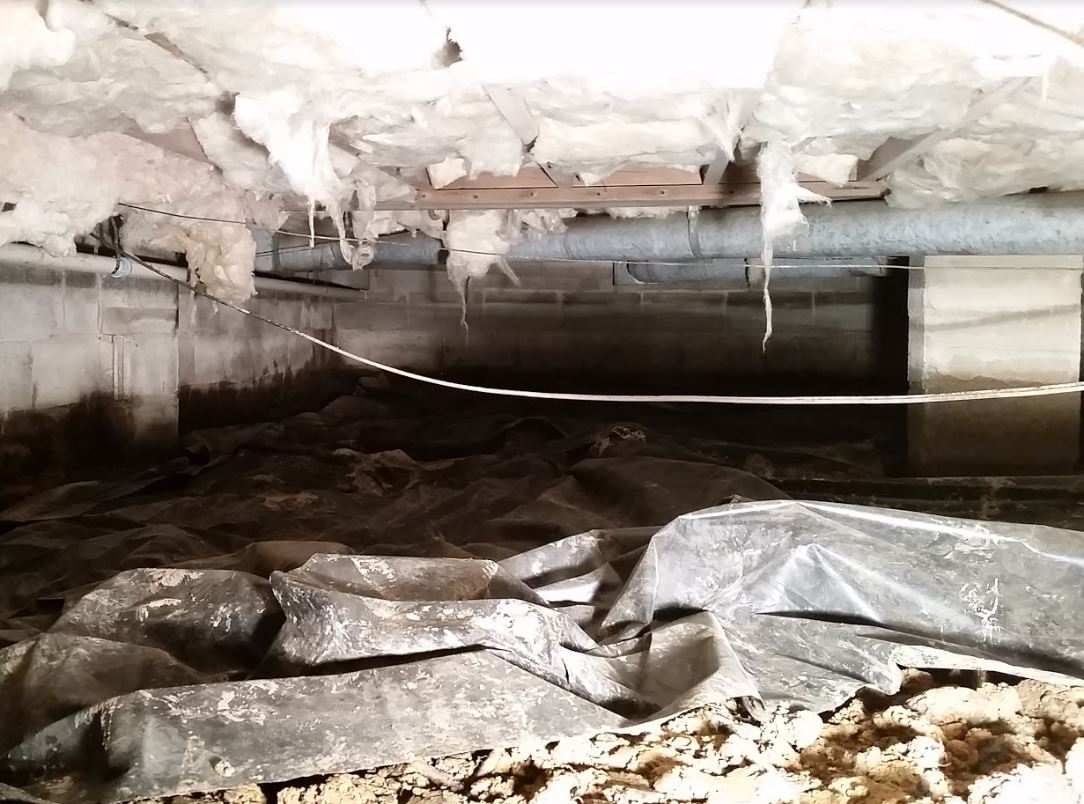 A wet and damaged crawl space