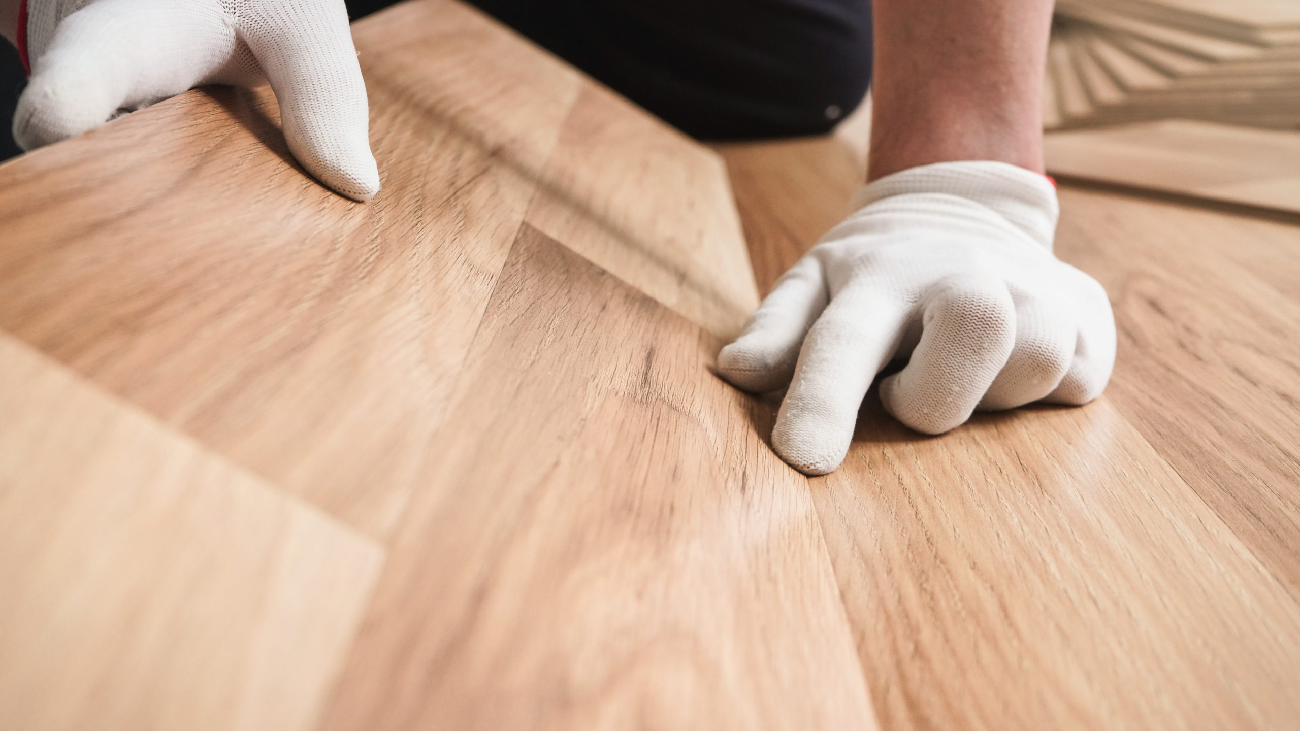 man installing wooden flooring